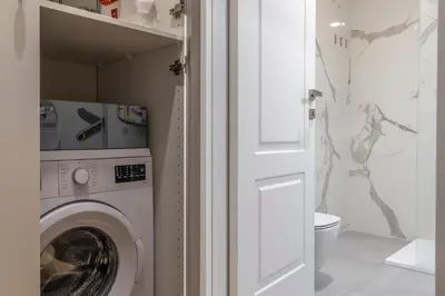 a laundry room with a washing machine in a bathroom at Villa Borghese Apartment in Rome