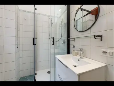 a bathroom with a sink and a shower with a mirror at L aROMA ANTICA in Rome