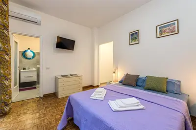 a bedroom with a purple bed with towels on it at L aROMA ANTICA in Rome