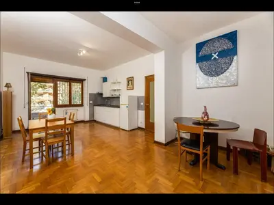 a kitchen and dining room with a table and chairs at L aROMA ANTICA in Rome