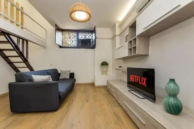a living room with a couch and a tv at Trastevere Experience in Rome