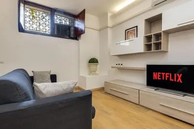 a living room with a couch and a tv at Trastevere Experience in Rome