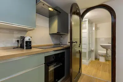 a kitchen with a sink and a stove top oven at Trastevere Experience in Rome