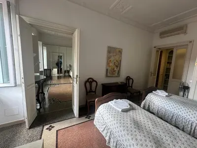 a bedroom with two beds and a mirror at Nel cuore di Roma in Rome