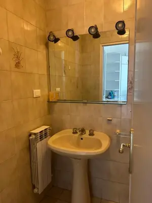 a bathroom with a sink and a mirror at Nel cuore di Roma in Rome