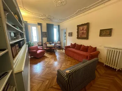 a living room with a red couch and chairs at Nel cuore di Roma in Rome