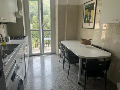 a kitchen with a table and chairs and a sink at Nel cuore di Roma in Rome
