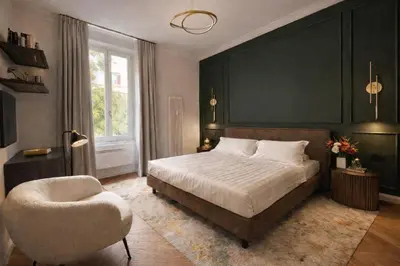 a bedroom with a large bed and a chair at Vatican Boutique - 2 bedroom apartment - Trilocale in Rome