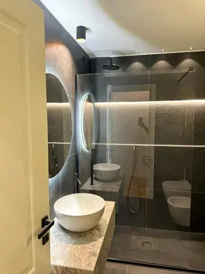 a bathroom with two sinks and a glass shower at Vatican Boutique - 2 bedroom apartment - Trilocale in Rome