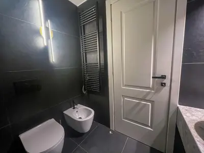 a bathroom with a toilet and a sink and a door at Vatican Boutique - 2 bedroom apartment - Trilocale in Rome
