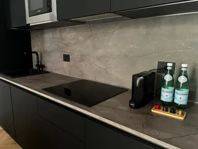 a kitchen counter with two bottles of alcohol and a toaster at Vatican Boutique - 2 bedroom apartment - Trilocale in Rome