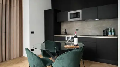 a glass table with chairs and a bottle of wine at Vatican Boutique - 2 bedroom apartment - Trilocale in Rome