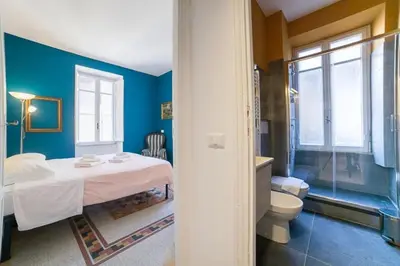 a room with a bed and a bathroom with a toilet at Monti 3 bedroom apartment Colisseum in Rome