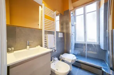 a bathroom with a white sink and a toilet at Monti 3 bedroom apartment Colisseum in Rome