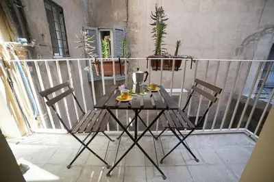 a table and two chairs on a balcony at Monti 3 bedroom apartment Colisseum in Rome