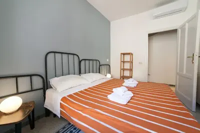 a bedroom with a bed with towels on it at Monti 3 bedroom apartment Colisseum in Rome