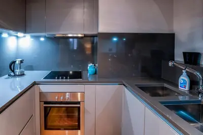 a kitchen with white cabinets and a stove top oven at Historic center apartment Rome in Rome