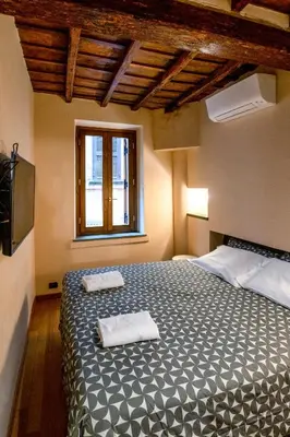 a bedroom with a bed with two towels on it at Historic center apartment Rome in Rome