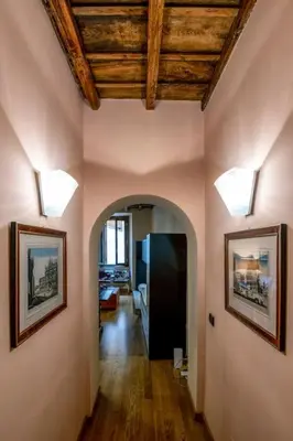 a hallway in a house with two lights on the walls at Historic center apartment Rome in Rome