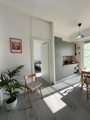 a kitchen with a table and a chair in a room at Paolettas House in Rome
