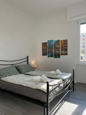 a bedroom with a bed with two towels on it at Paolettas House in Rome