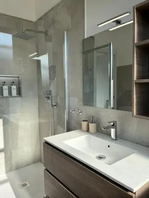a bathroom with a sink and a shower at Paolettas House in Rome