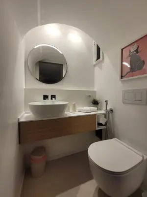 a bathroom with a sink and a toilet and a mirror at Mini Loft MaDi' in Rome