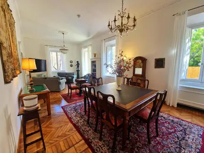 a dining room and living room with a table and chairs at Angel's Garden in Rome
