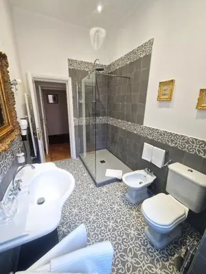 a bathroom with a sink and a toilet and a shower at Angel's Garden in Rome