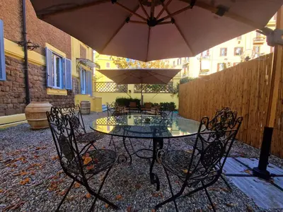 a table and chairs with an umbrella on a patio at Angel's Garden in Rome