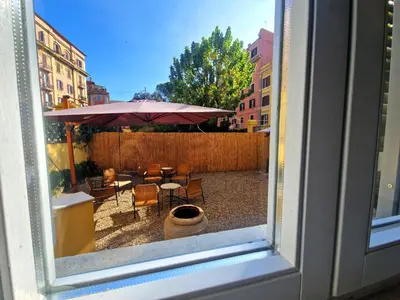 a view of a patio with a table and an umbrella at Angel's Garden in Rome