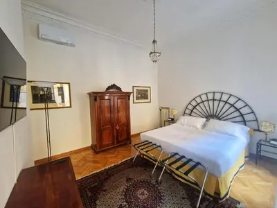 a bedroom with a bed and a dresser in it at Angel's Garden in Rome