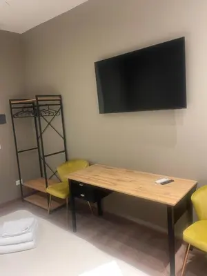 a room with a table and chairs and a television on the wall at Stazione Tiburtina Roma in Rome