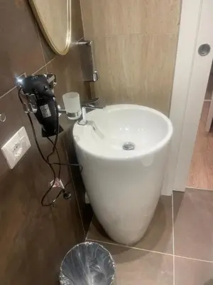 a bathroom with a white sink in a room at Stazione Tiburtina Roma in Rome