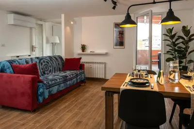 a bedroom with a bed with a desk and a desk at Attichetto Monteverde in Rome