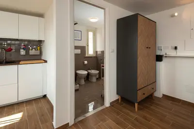 a kitchen with a wooden table and black chairs at Attichetto Monteverde in Rome