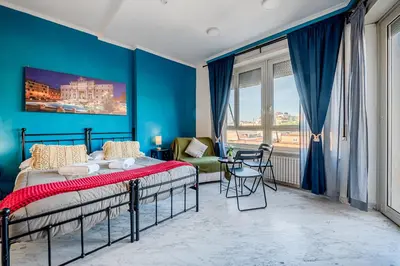 a bedroom with a bed and a blue wall at Domus Antica Trastevere in Rome
