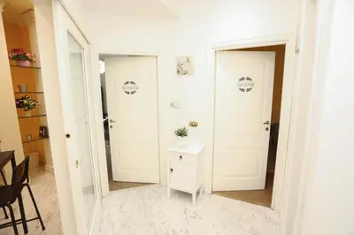a hallway with a mirror and a small table at Domus Antica Trastevere in Rome