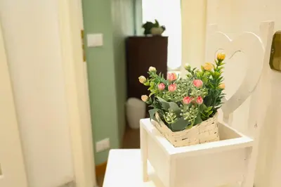 a basket of flowers on a table in a room at Domus Antica Trastevere in Rome