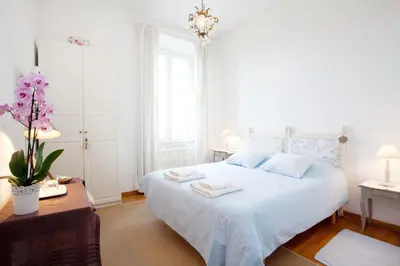 a bedroom with a white bed with towels on it at B&B Ondina in Rome