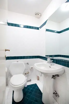 a bathroom with a white toilet and a sink at B&B Ondina in Rome