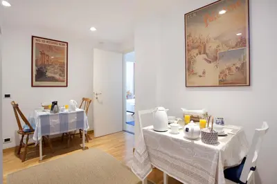 a dining room with two tables with white table cloth at B&B Ondina in Rome