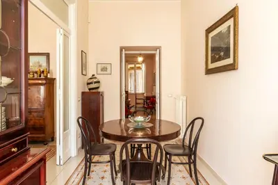 a dining room with a table and chairs at GuestHost - Sapienza University Elegant Apartment! in Rome