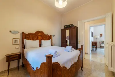 a bedroom with a large bed with towels on it at GuestHost - Sapienza University Elegant Apartment! in Rome