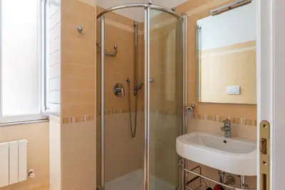 a bathroom with a shower and a sink at GuestHost - Sapienza University Elegant Apartment! in Rome