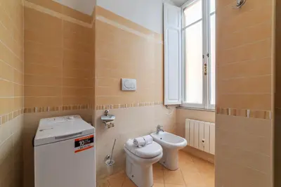 a small bathroom with a toilet and a sink at GuestHost - Sapienza University Elegant Apartment! in Rome