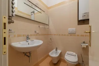 a bathroom with a sink and a toilet at GuestHost - Sapienza University Elegant Apartment! in Rome