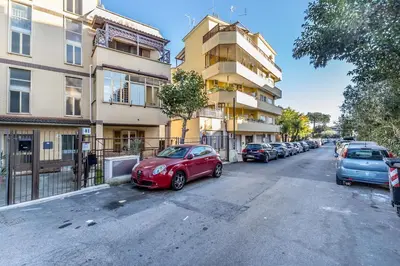 a red car parked on the side of a street at A Casa di Max - Battistini Station 