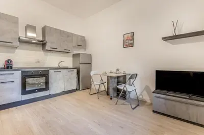 a kitchen with a table and a dining room at A Casa di Max - Battistini Station 