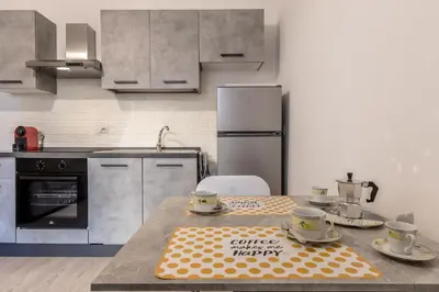 a kitchen with a table with two cups on it at A Casa di Max - Battistini Station 